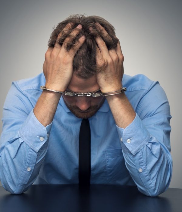 White,Collar,Crime,Concept,-,Desperate,Businessman,With,Handcuffs